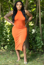 Load image into Gallery viewer, A woman wearing a sleeveless, orange mini dress with a mock neckline and side slit, standing in a wooded area.
